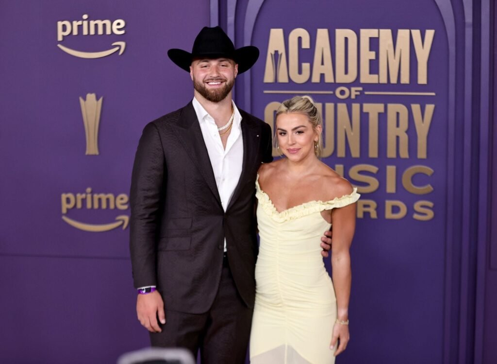 Jake Ferguson swoons as “wife” Haley Cavinder blows kiss in red bikini at 2026 SI Swimsuit Runway Show
